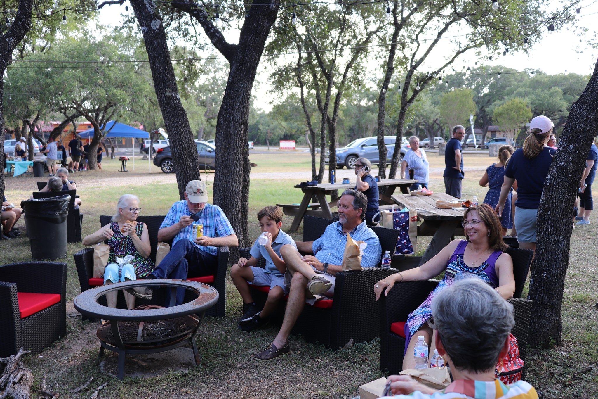 People gathering around a firepit