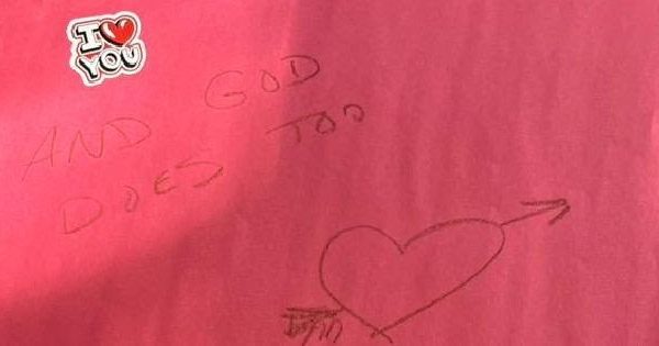 A Pink Piece Of Paper With A Sticker On It That Says, "I Love You," And Writing That Says, "and God Does Too" Along With A Heart, Underneath The Sticker.